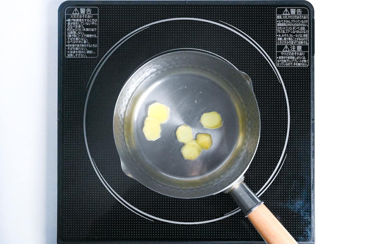 slices of fresh ginger heating in water