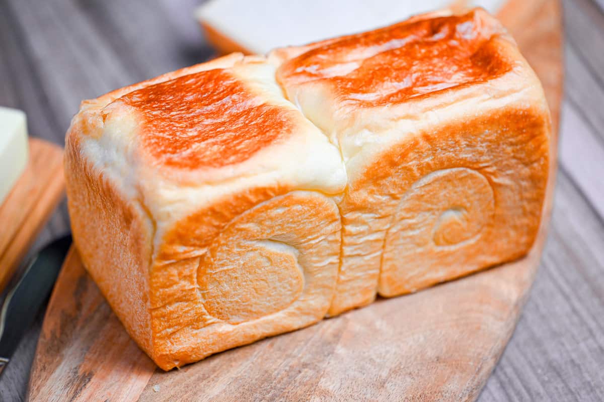 homemade nama shokupan loaf on a wooden chopping board