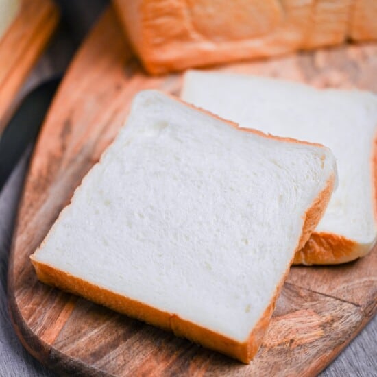 2 slices of nama shokupan on a wooden chopping board
