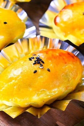 Japanese sweet potato dessert in foil cases sprinkled with black sesame seeds