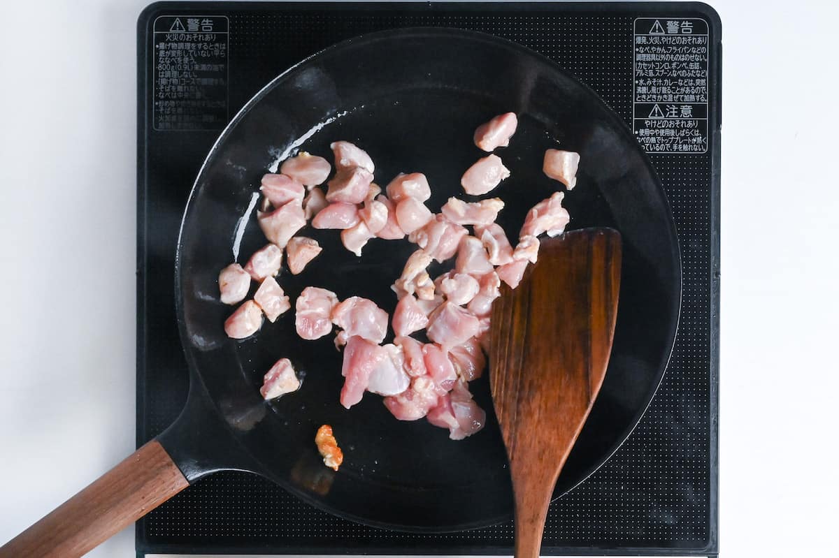 frying chicken thigh in a frying pan