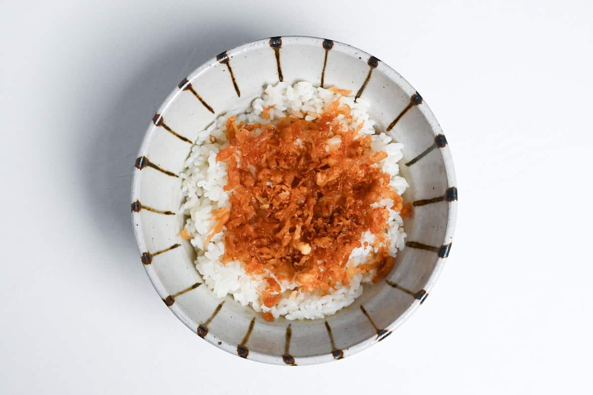 rice in a bowl topped with tempura flakes