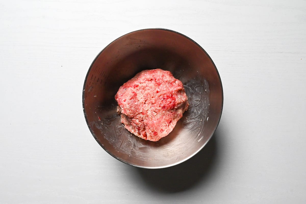 beef mince, pork mince and finely chopped beef cuts kneaded together with panko, salt, pepper and nutmeg