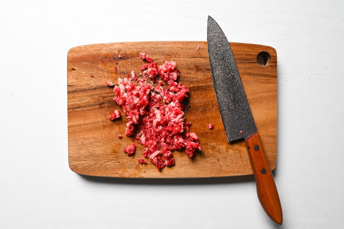 finely chopped beef on a wooden chopping board