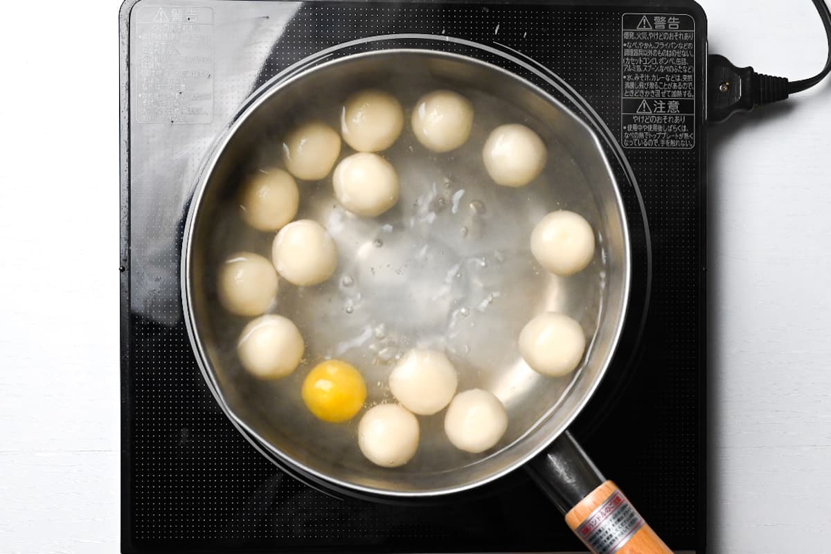 floating dango boiling in a pot