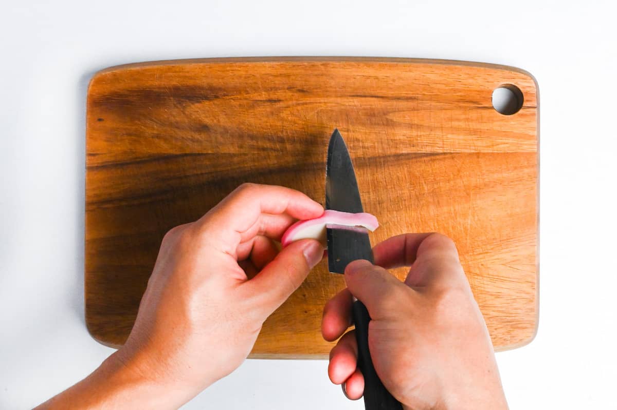 cutting the pink part of a slice of kamaboko to make rabbit ears