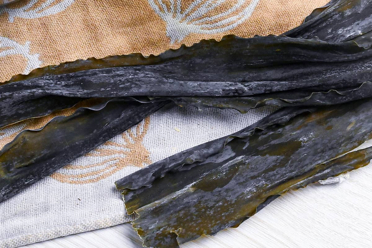 kombu (dried kelp) on an white and brown tea towel with onion design