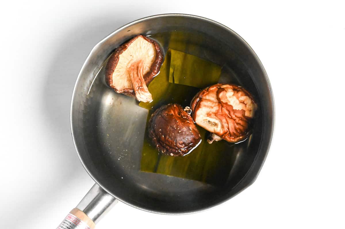 dried shiitake mushrooms and kombu soaking in a pot of water