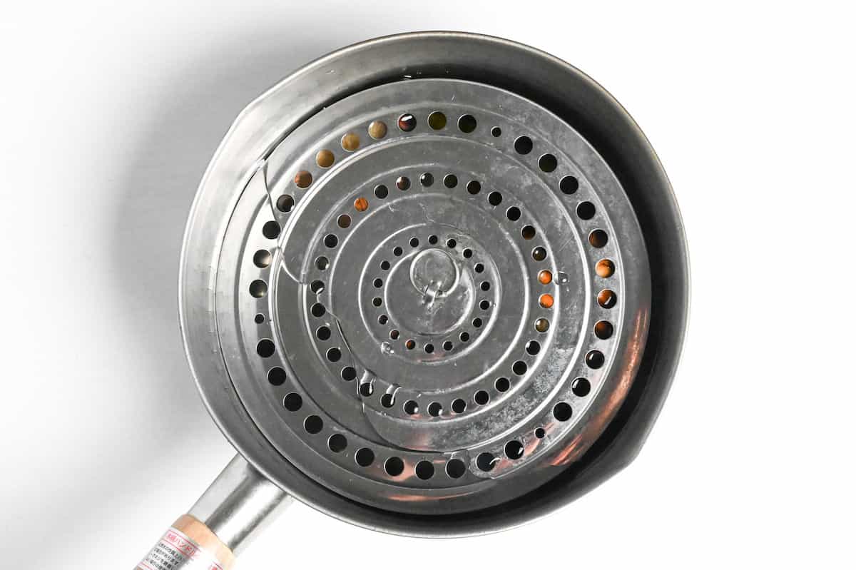 vegan dashi with shiitake and kombu in water weighed down with a drop lid