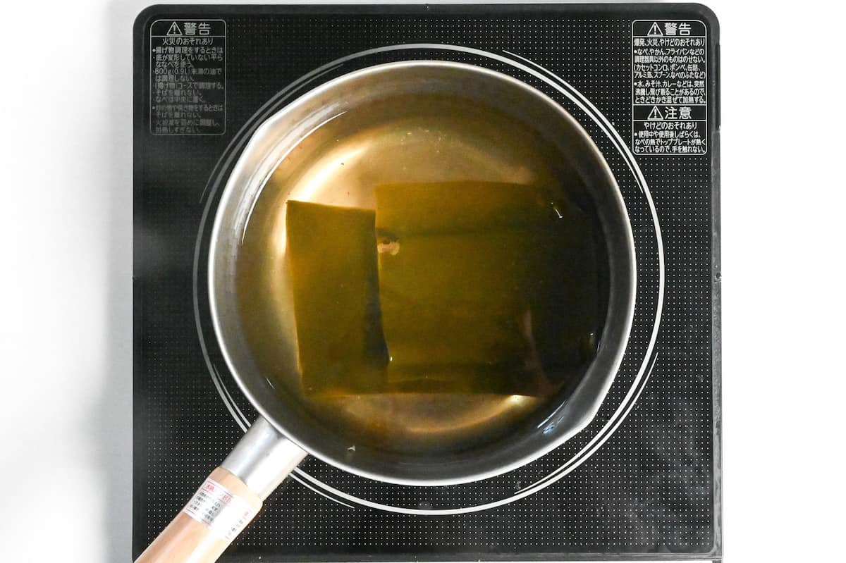 vegan awase dashi in a pot of the stove with shiitake removed