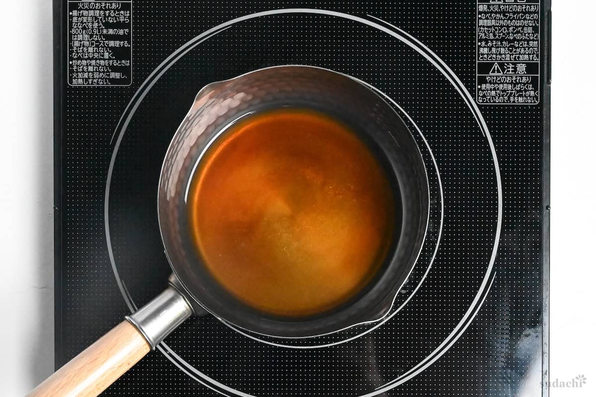 Sauce for enoki and bok choy wasabi-ae in a saucepan on the stovetop