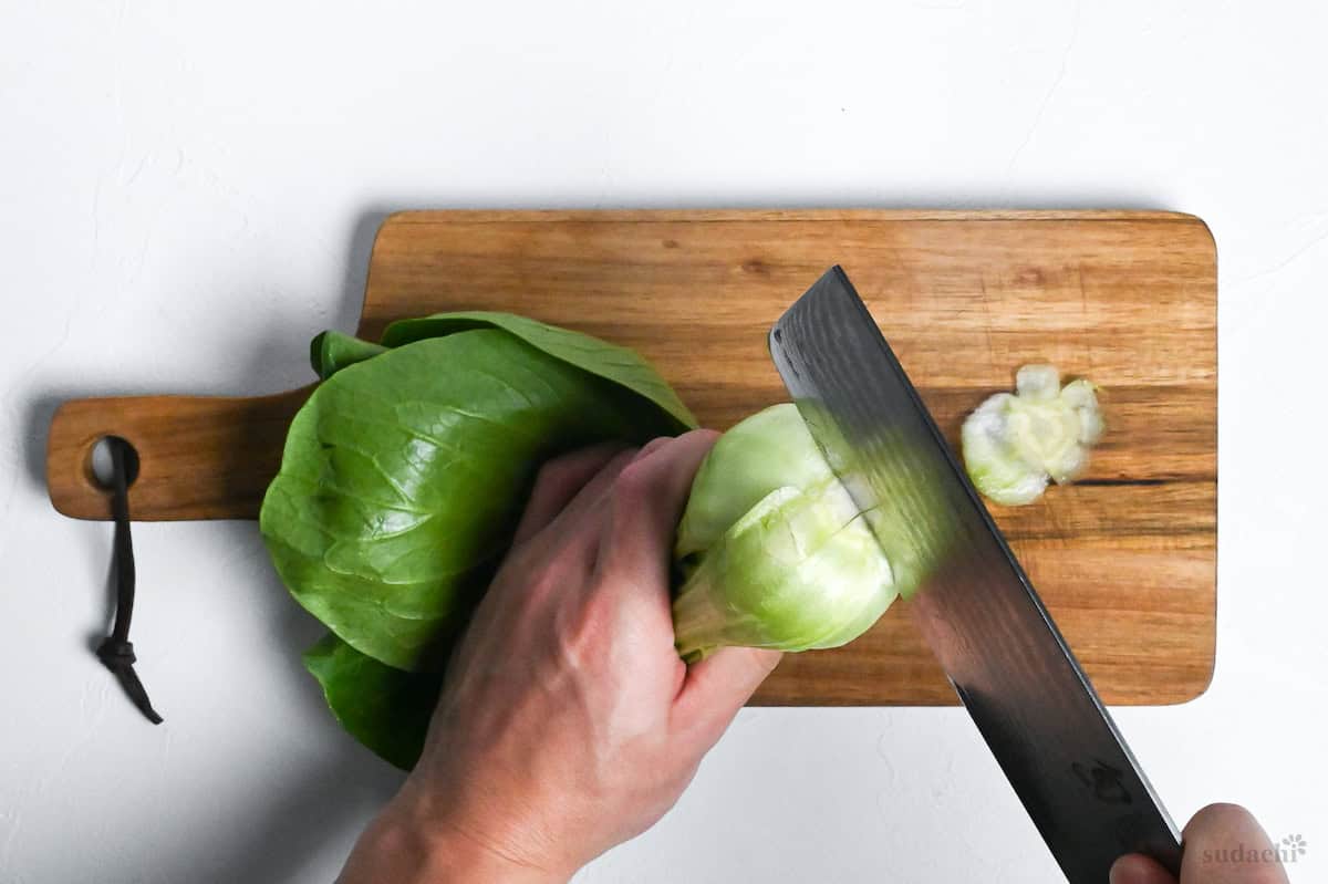 cutting a cross on the base of a bok choy with a Japanese knife