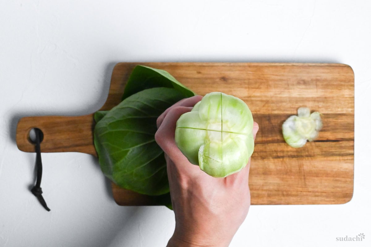 A cross cut into the base of a bok choy