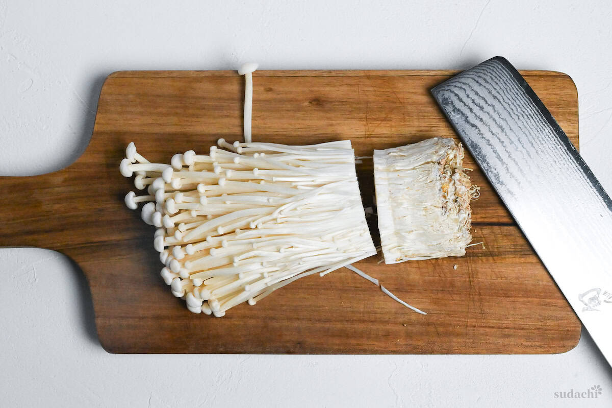 the roots cut off of enoki mushrooms