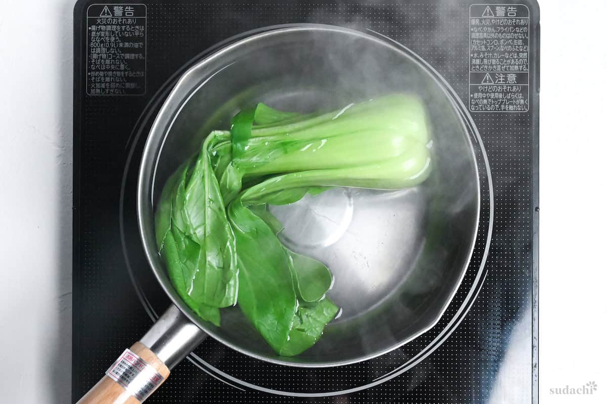 bok choy in a pot of hot water on the stovetop