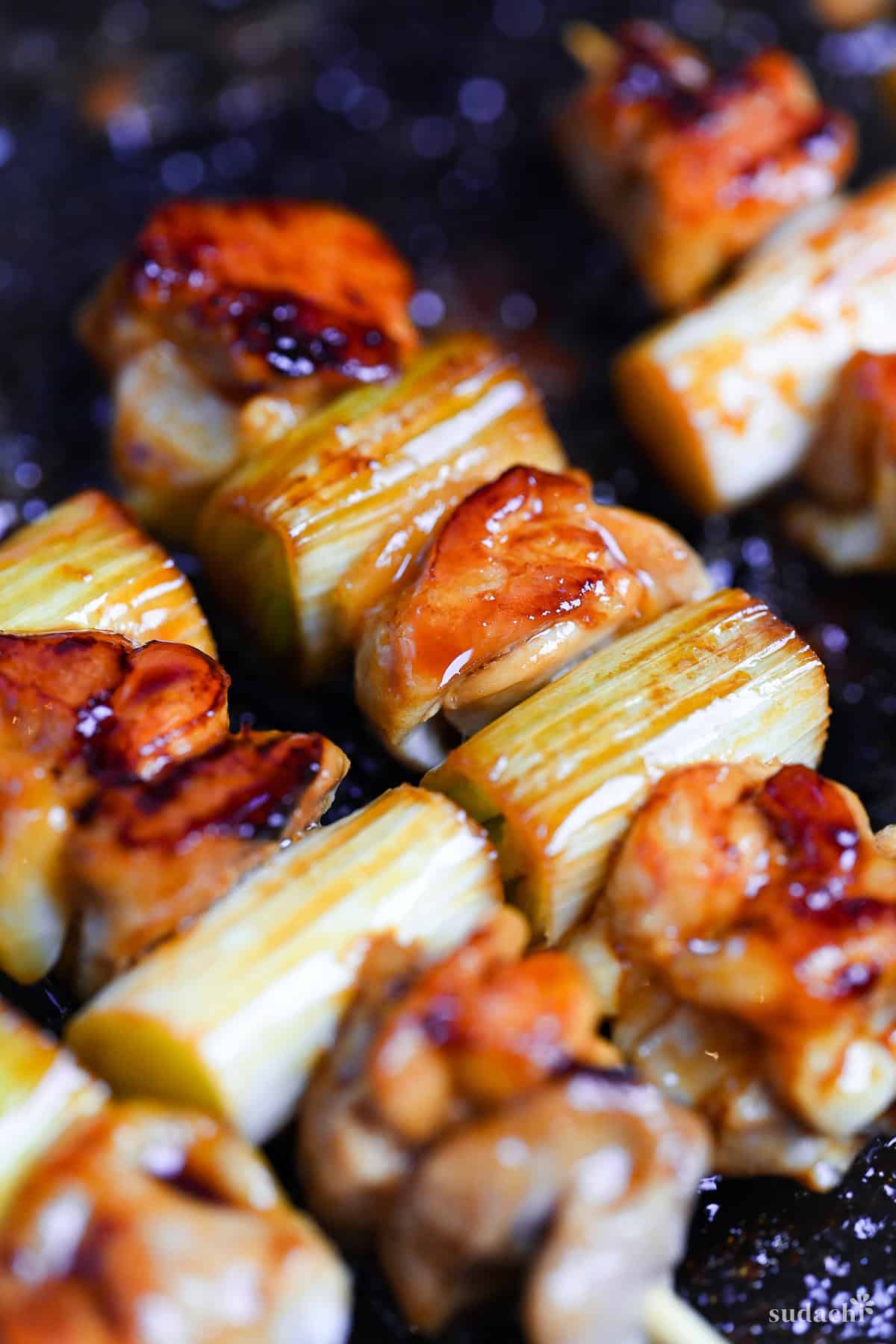 frying Japanese yakitori at home in a frying pan
