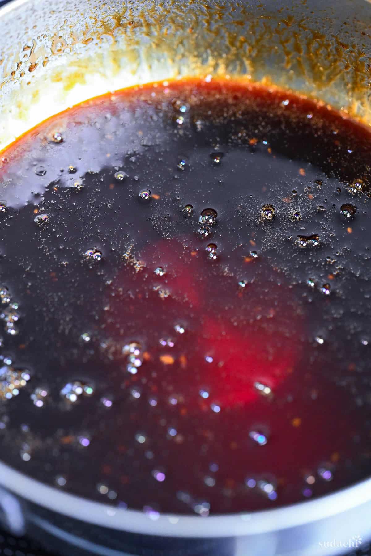 homemade yakitori sauce bubbling in a saucepan close up