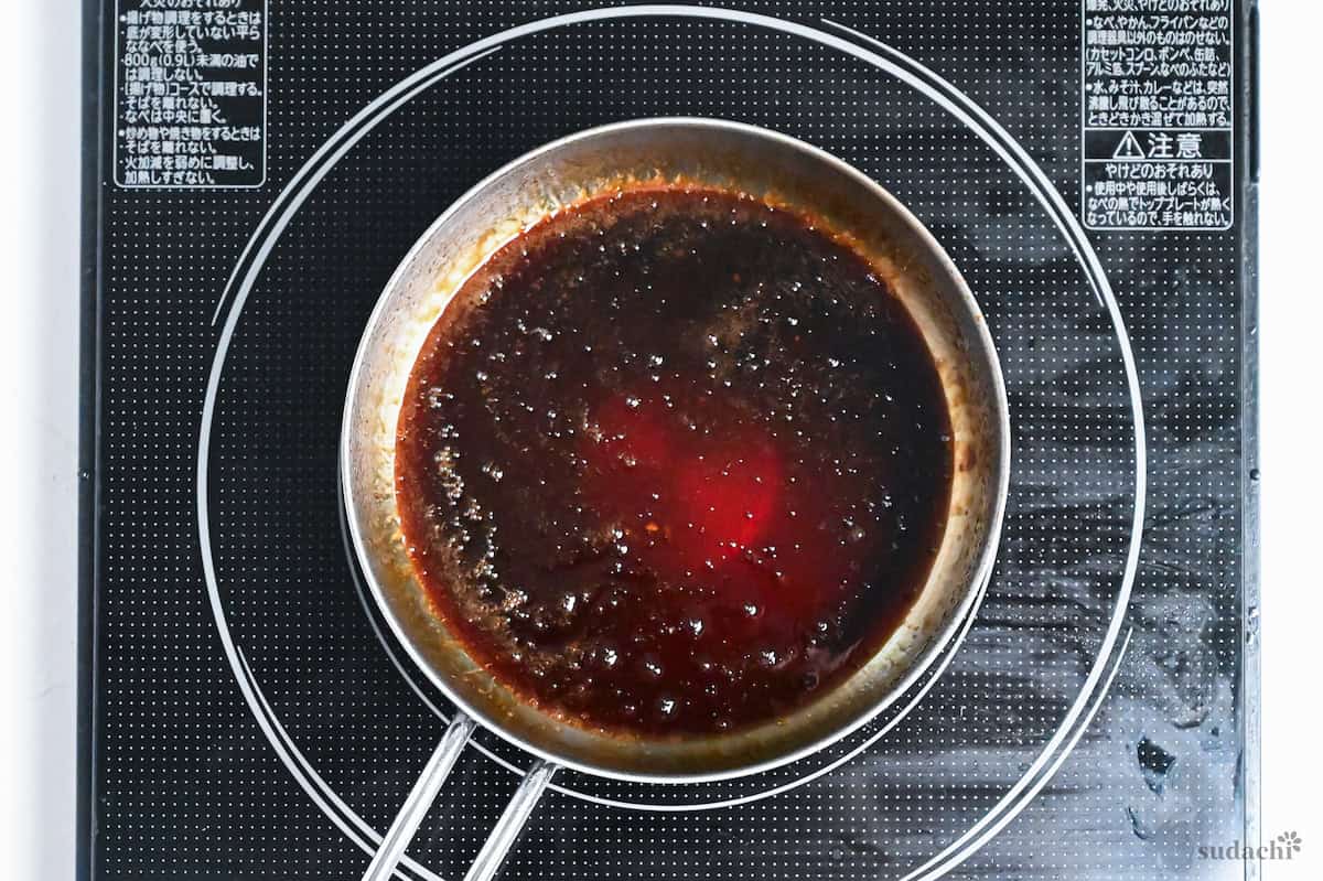 homemade yakitori sauce bubbling in a saucepan on the stove