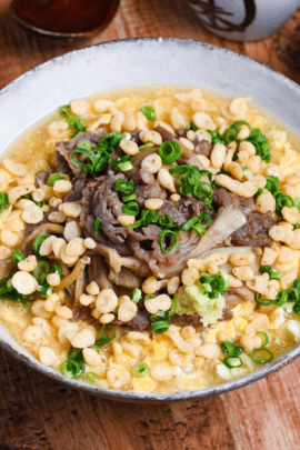 Nikutama Ankake Soba (Beef & Egg Soba Noodle Soup) in a white and brown bowl